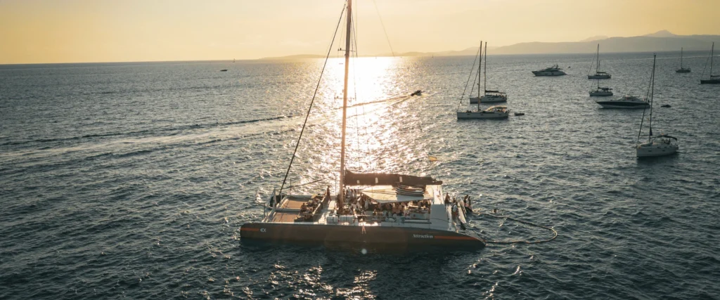 Sunset postcard of one of Attraction Catamarans’ boats sailing across the Mediterranean in June.